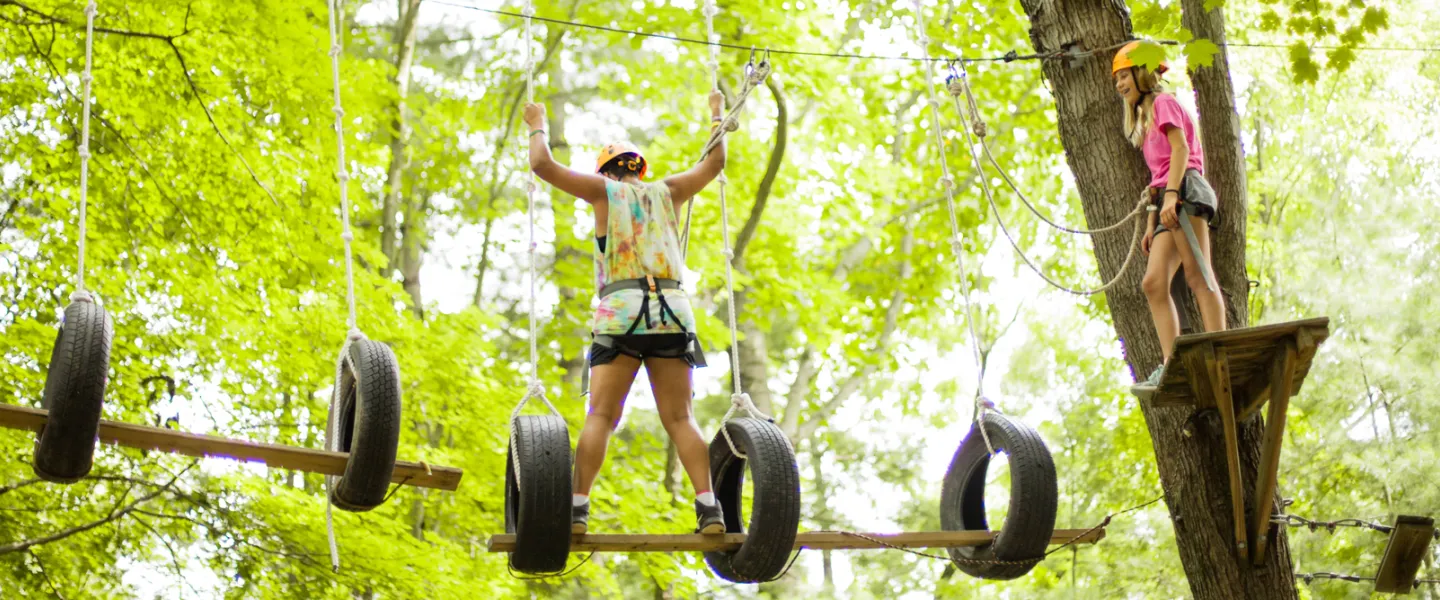 Girls on the high ropes at camp