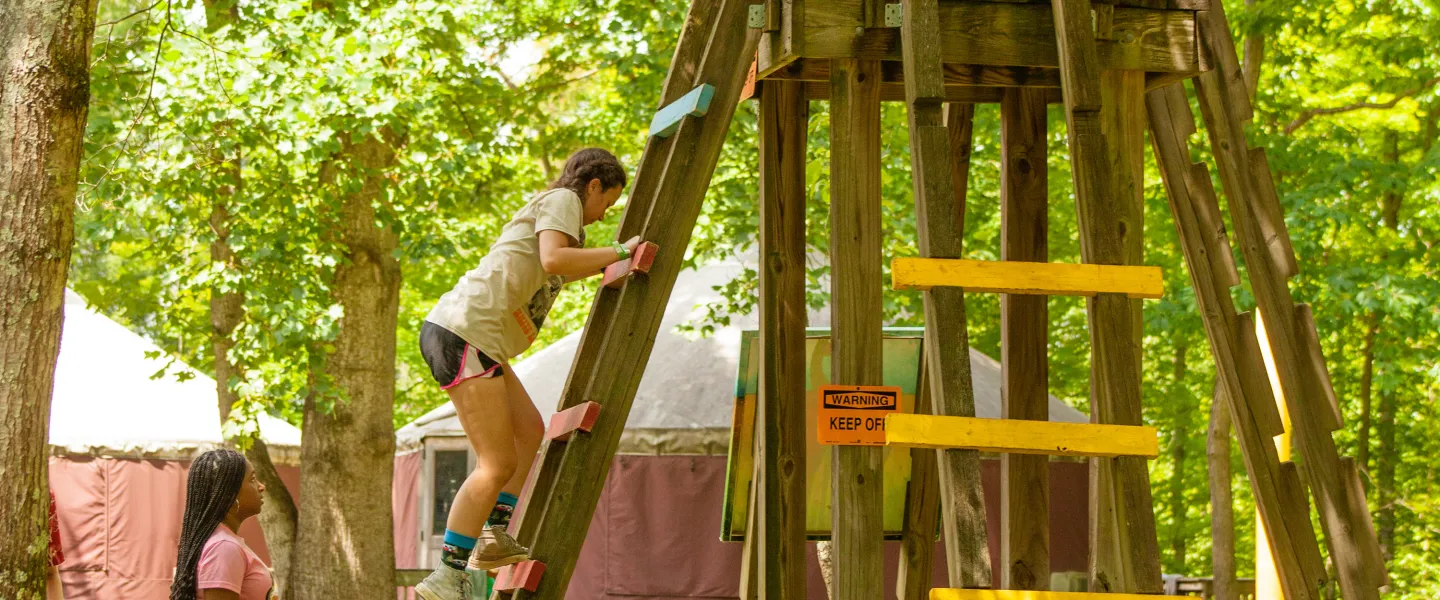 kids at camp solving an obstacle together