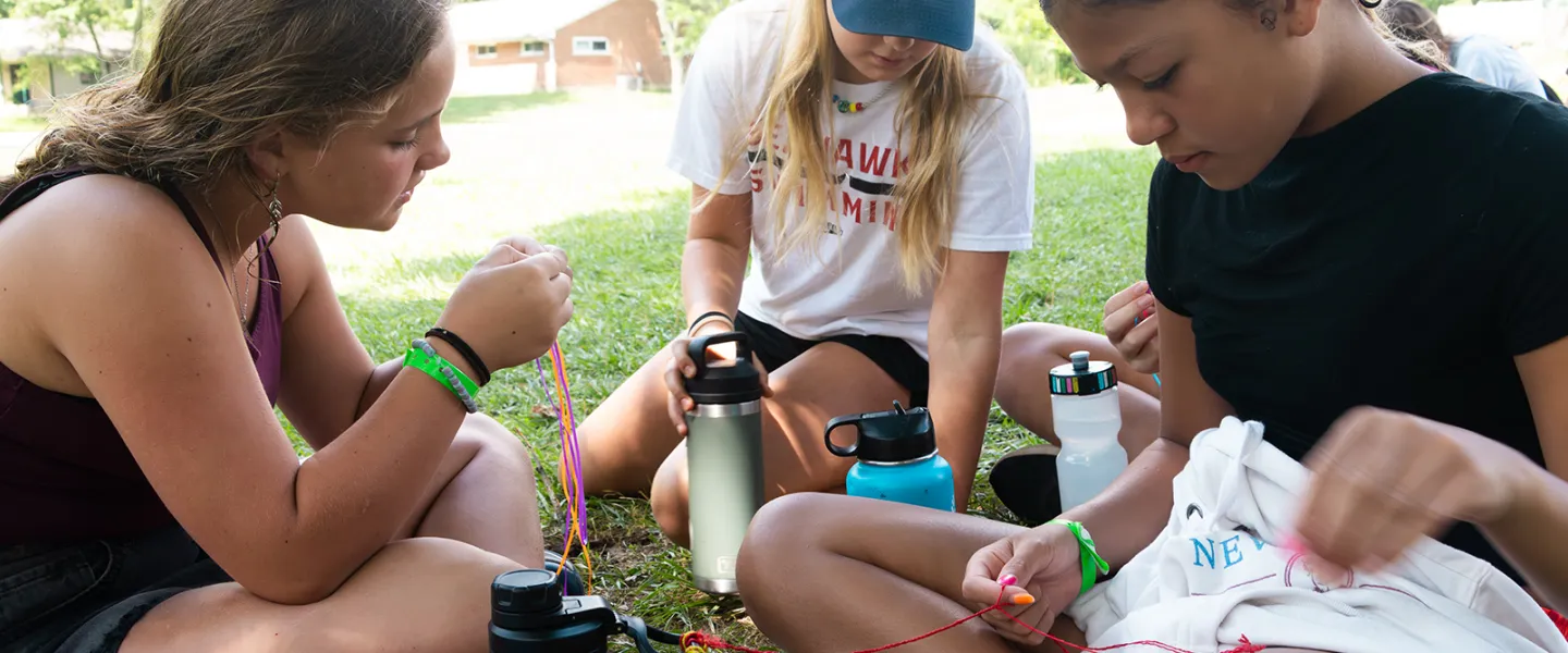 Making bracelets at camp