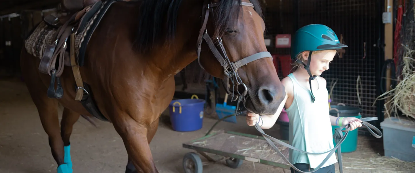 Girl with horse at camp