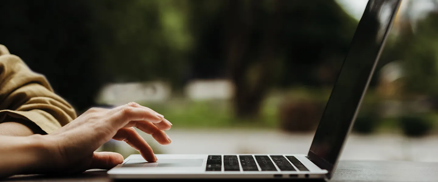 A person on a laptop outdoors