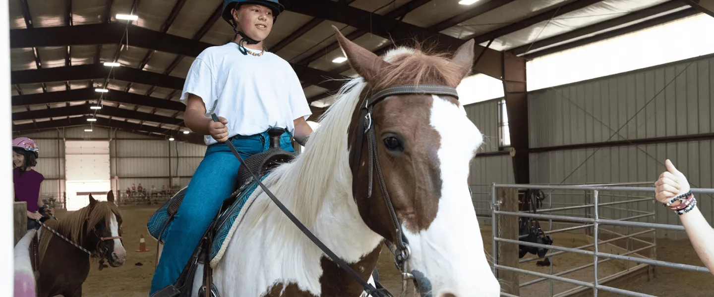 A boy on a horse at Camp