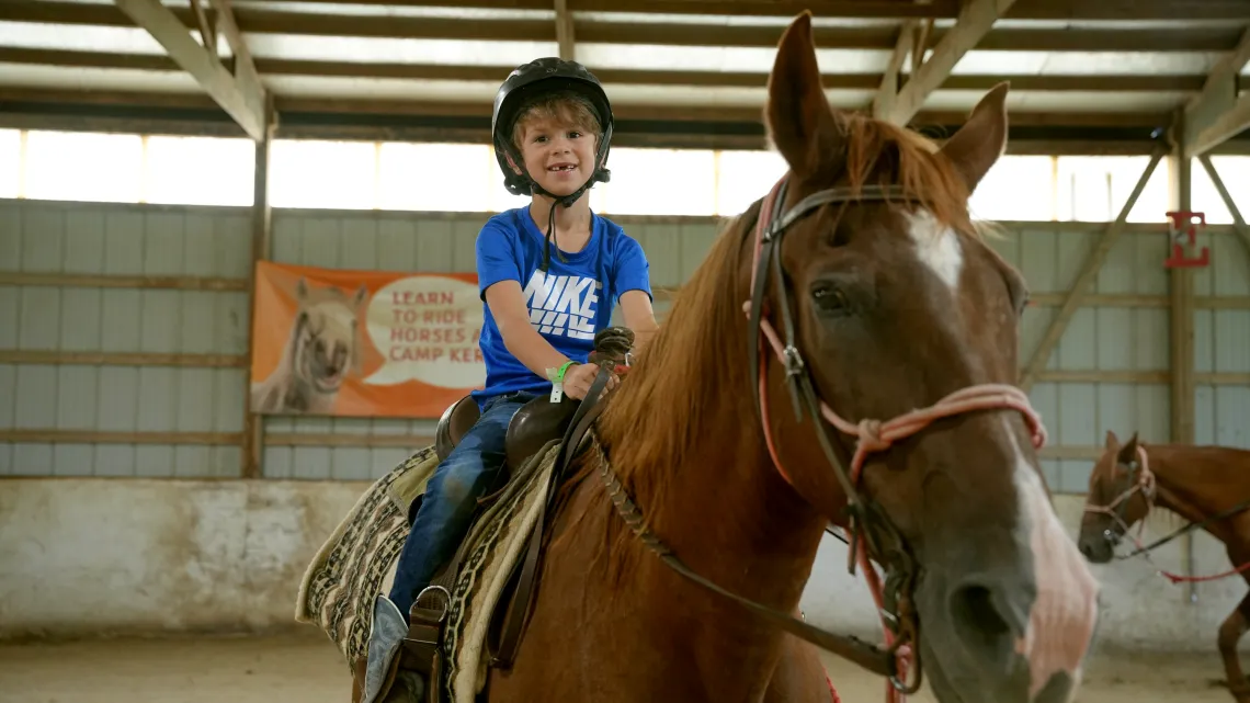 A boy on a horse at camp kern