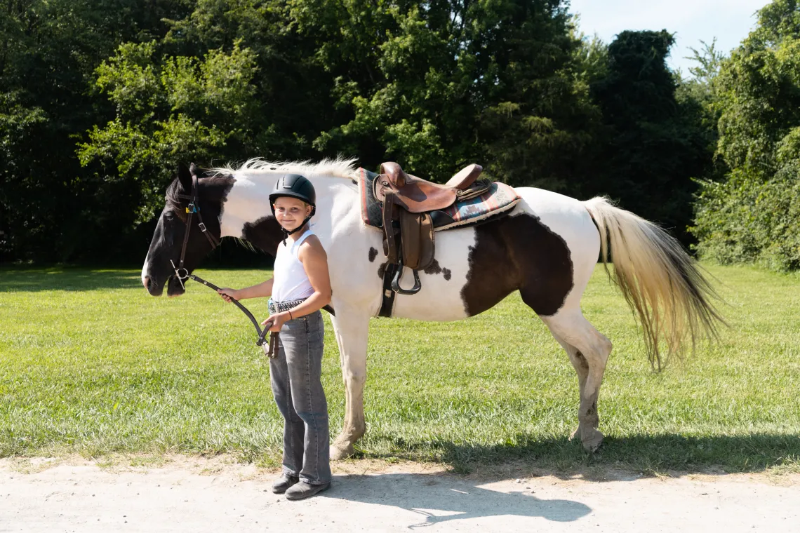 A girl with a horse outdoors