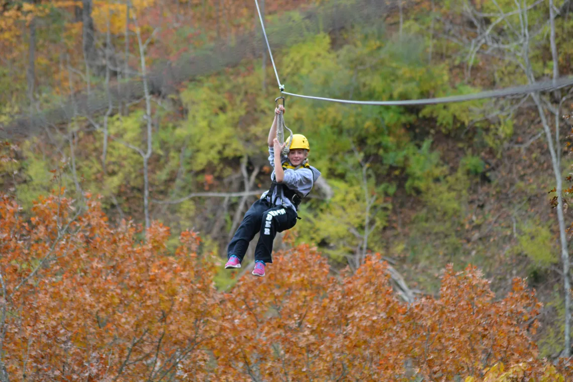 A boy ziplining at Ozone Zipline Adventures