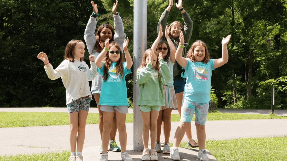 A group of girls at camp doing a morning chant