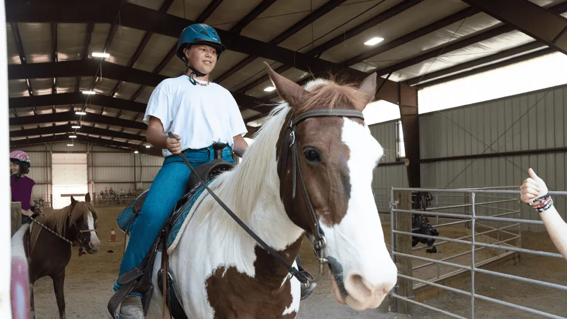 A boy on a horse at Camp 